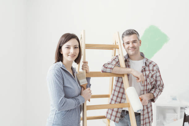 istock Couple painting their house 939597576
