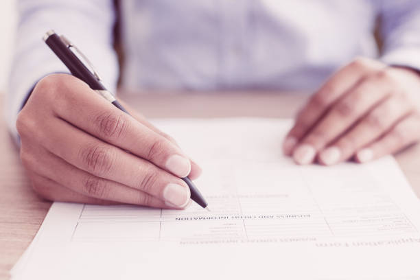 istock Closeup of Person Completing Application Form 939598350