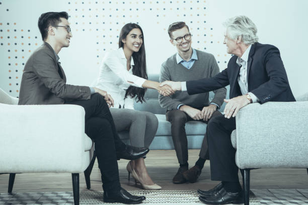 istock Young and Senior Business People Shaking Hands 939600618