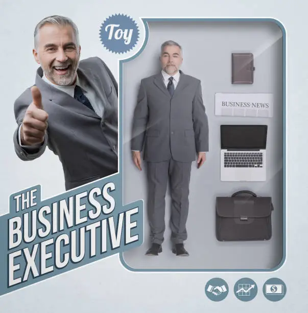 Business executive lifelike doll with see through toy packaging, accessories and smiling businessman giving a thumbs up