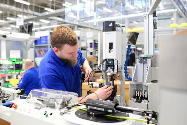 istock operator assembles machine in a factory - production of switch cabinets for industrial plant 939601910