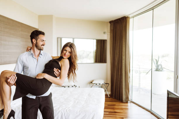 istock Couple entering at home embracing 939605144