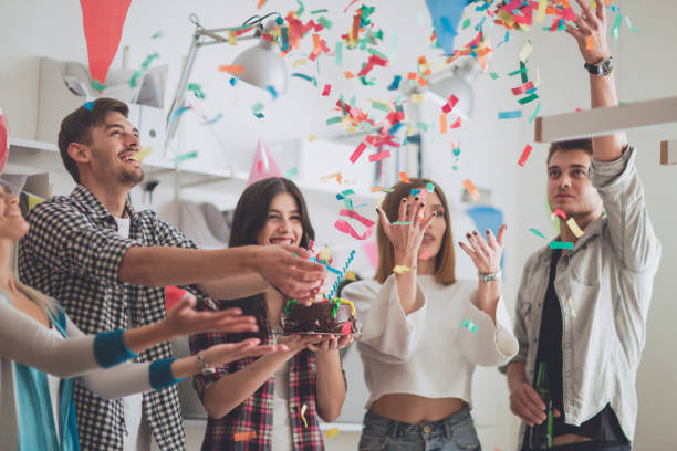 istock Young colleagues celebrating birthday party in modern office 939605188
