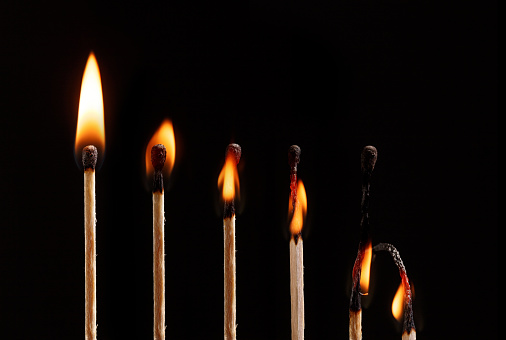Different stages of match burning matches isolated on black background