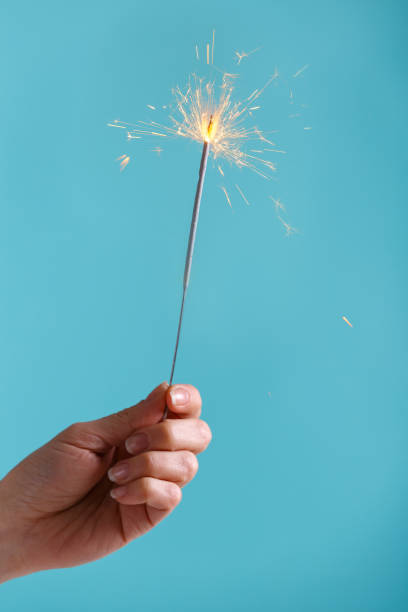 istock Female hands holding bengal light. 939610440