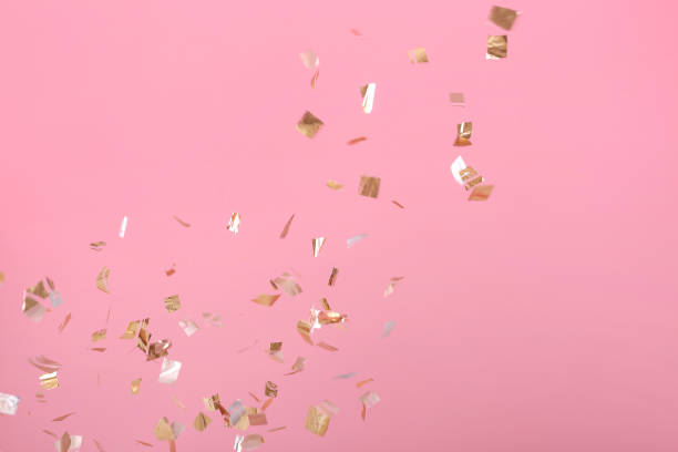 istock Golden confetti on pink background 939610714