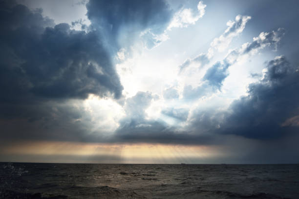 istock Sunset in a cloudy sky over open Baltic sea with veri distant ship silhouettes. 939611050