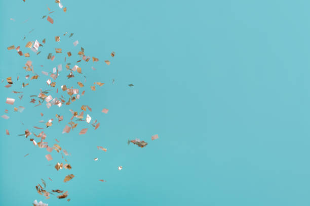 istock Golden confetti on pink background 939615288