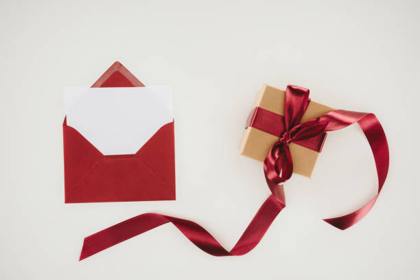 istock top view of red envelope with blank paper and gift box isolated on white 939625426