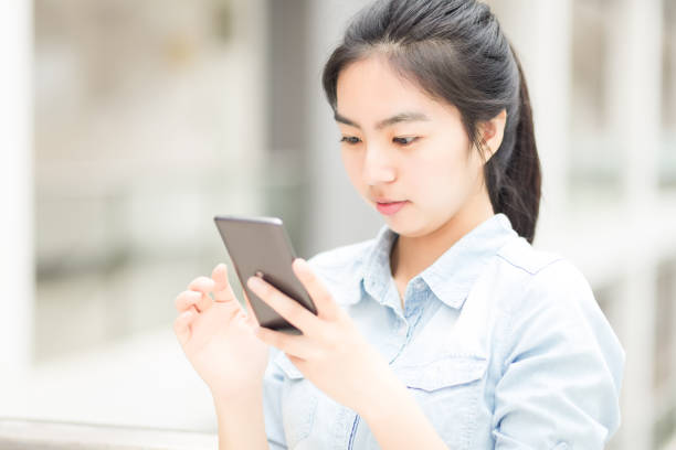 istock Young girl operating mobile phone 939637250