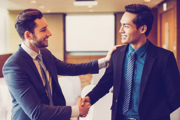 istock Smiling Business Leader Congratulating Colleague 939637930