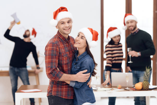istock A young couple celebrates at a corporate celebration. 939643440