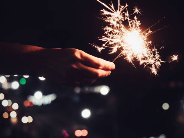 istock Festive, bright, burning Bengal lights in the man's hand 939645728