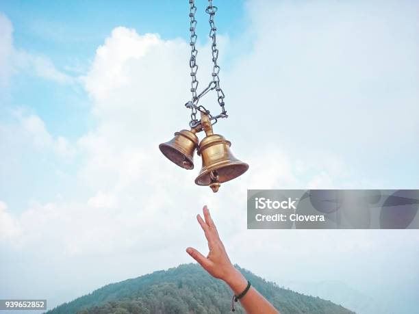 Devotees Hand Trying To Hit Hindu Temple Bells Stock Photo - Download Image Now - Bell, Hinduism, Spirituality