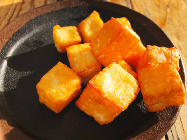 istock Deliciously fried cheese cubes on a dark plate. 939653860