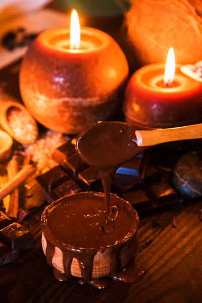 istock Spa concept with chocolate and candles on a wooden background. 939659474