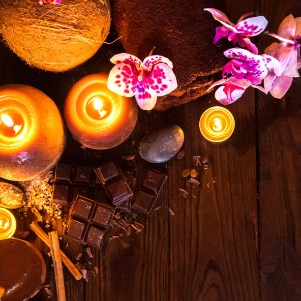 istock Spa concept with chocolate and candles on a wooden background. 939659736