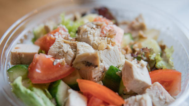 istock Take away salad with  tomatoes and chicken in plastic packaging. A useful snack for office workers in the workplace 939669702