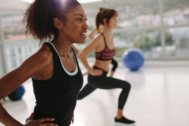 istock Woman exercising in gym class 939670030