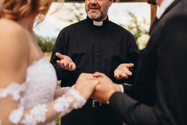 istock Priest giving blessings to bride and groom 939675476