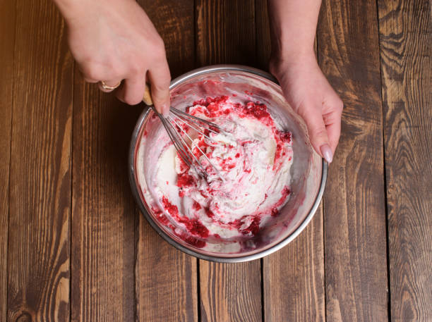 Delicious bowl of strawberry ice cream. Homemade cooking Raspberry ice cream with berries and mint, served in glasses on an old wooden desk homemade icecream stock pictures, royalty-free photos & images