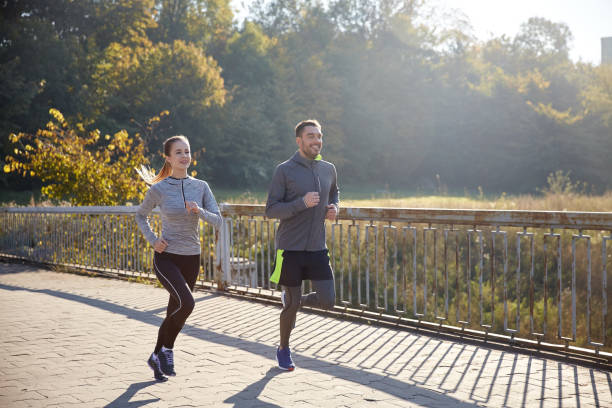istock happy couple running outdoors 939681046