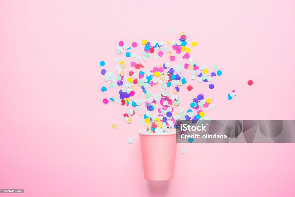 Drinking Paper Cup with Multicolored Confetti Scattered on Fuchsia Background. Flat Lay Composition. Birthday Party Celebration Kids Fun Cheerful Atmosphere. Greeting Card Poster Template. Copy Space Drinking Paper Cup with Multicolored Confetti Scattered on Fuchsia Background. Flat Lay Composition. Birthday Party Celebration Kids Fun Cheerful Atmosphere. Greeting Card Poster Template Confetti Stock Photo