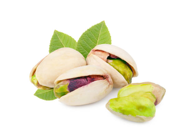istock Pistachios with leaves isolated on white background 939686788