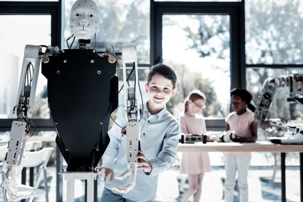 istock Smart child in casual posing with robotic machine 939693034