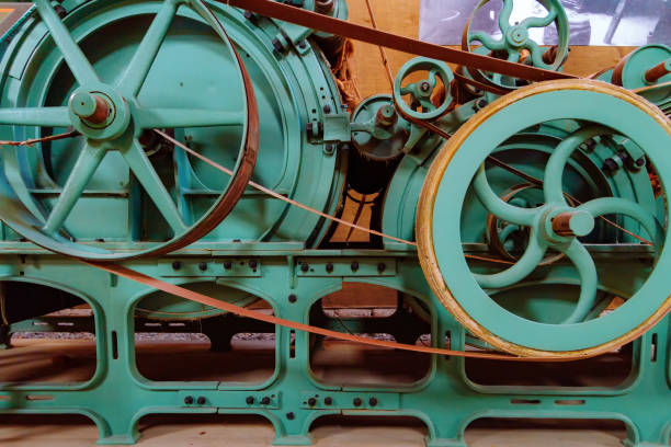 istock Pulleys and gears of old wool processing machine 939693264