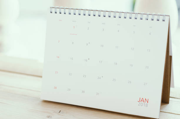 istock Desktop Calendar 2018 on page january on wood board or wood table. 939693482