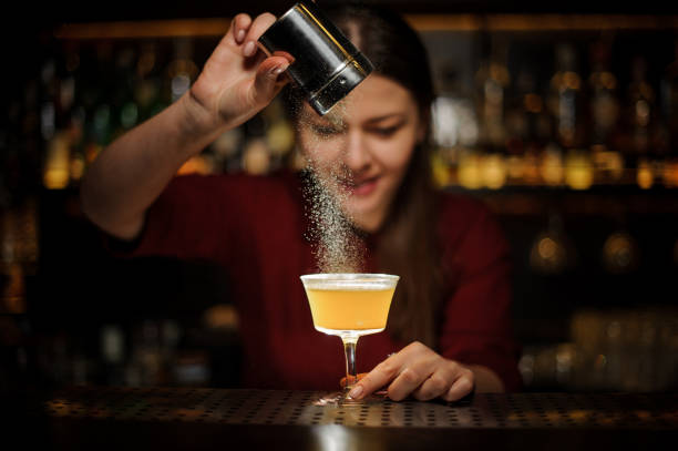 istock Female bartender pouring a spice to the fresh cocktail 939694246