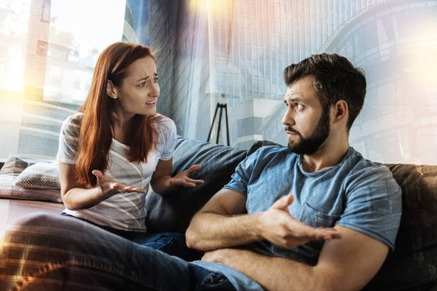 istock Disappointed woman looking at her boyfriend and feeling miserable 939695160