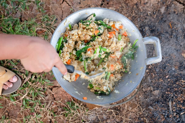 istock Chef stir fried rice with vegetables and fried eggs on stove 939695464