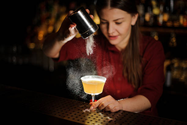 istock Female bartender pouring a spice to the illuminated cocktail 939695628