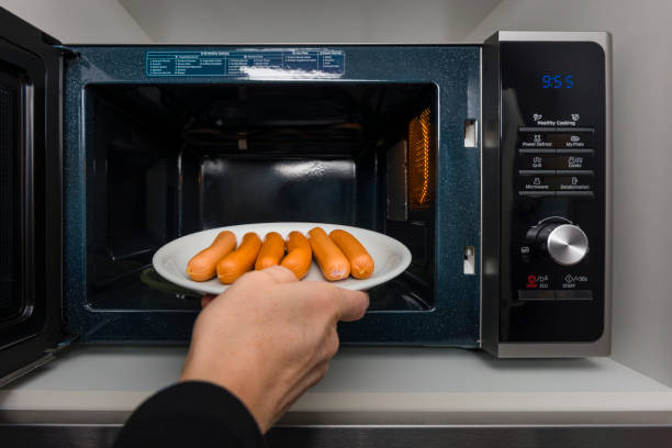 istock heating wiener in microwave oven 939698192