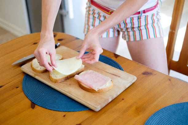istock woman making breakfast, hands closeup 939704480