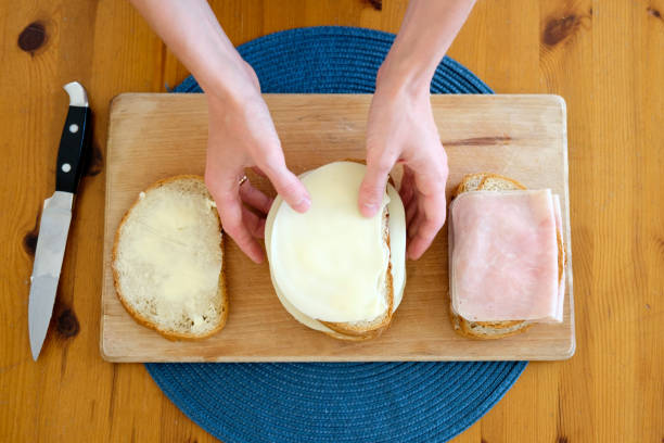 istock woman making breakfast, hands closeup 939704486