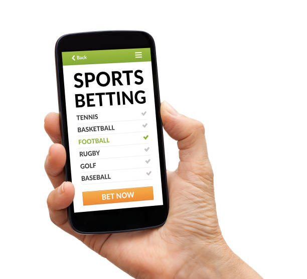 Hand holding smart phone with sports betting concept on screen stock photo