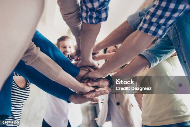 Low Angle Cropped View Of Colleagues Putting Their Hands On Top Of Each Other Wearing Casual Clothes Concept Of Successful Teambuilding And Unity Stock Photo - Download Image Now