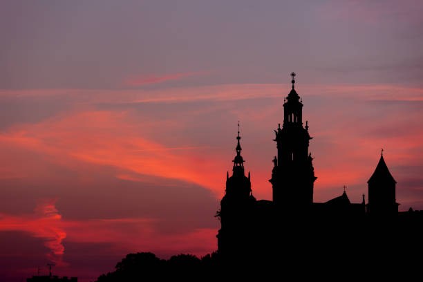 Krakow, Poland, Wawel Royal Castle and Cathedral towers skyline silhouette at dusk.