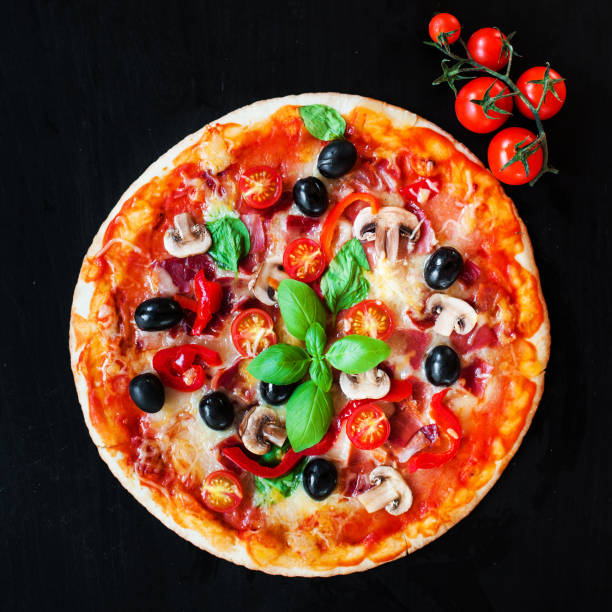 istock Hot pizza with Pepperoni Sausage on a dark background  with copy space. Cheese Pizza 