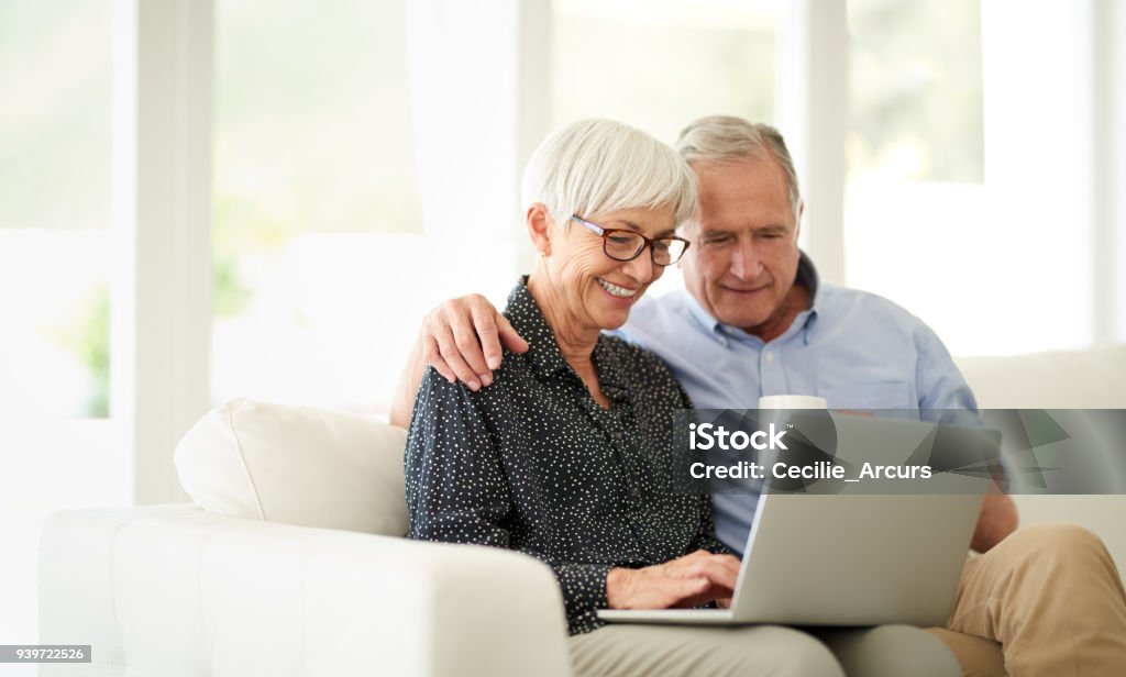 Have you seen this? Cropped shot of an affection senior couple using their laptop while relaxing at home Laptop Stock Photo