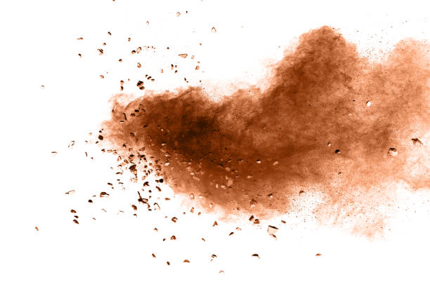 istock Brown color powder with small stone explosion cloud isolated on white background.Closeup of Brown dust particles splash isolated on  background. 939729228