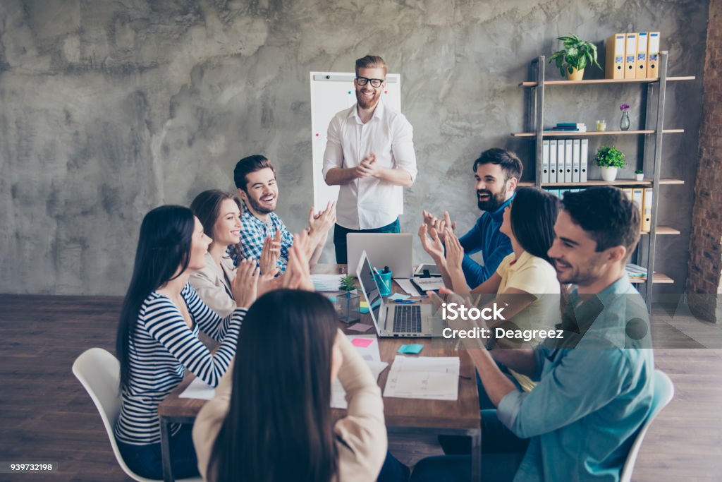 Gret job! Successful business team is clapping their hands in modern workstation, celebrating the performance of new product Manager Stock Photo