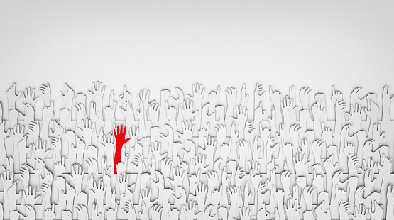 A red hand standing out from a sea of white hands, paper cut-out, 3D