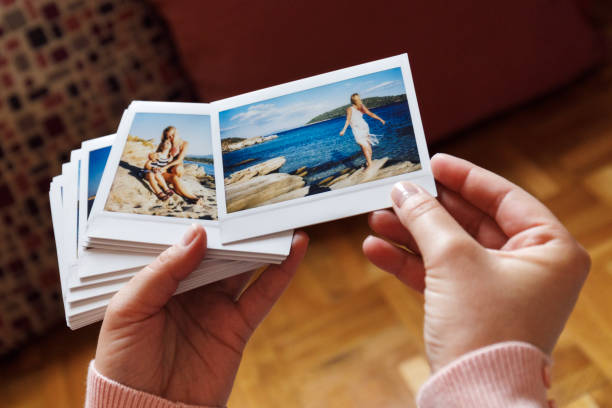 istock Browsing vacation photographs at home - a closeup 939733406