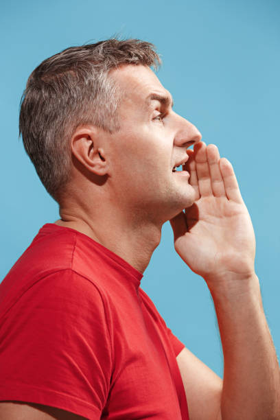 istock Isolated on pink young casual man shouting at studio 939745374