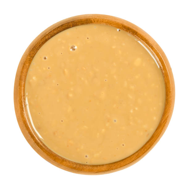 istock Crunchy peanut butter in wooden bowl over white 939745730