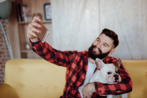 istock Bearded man taking selfie with his dog 939745972